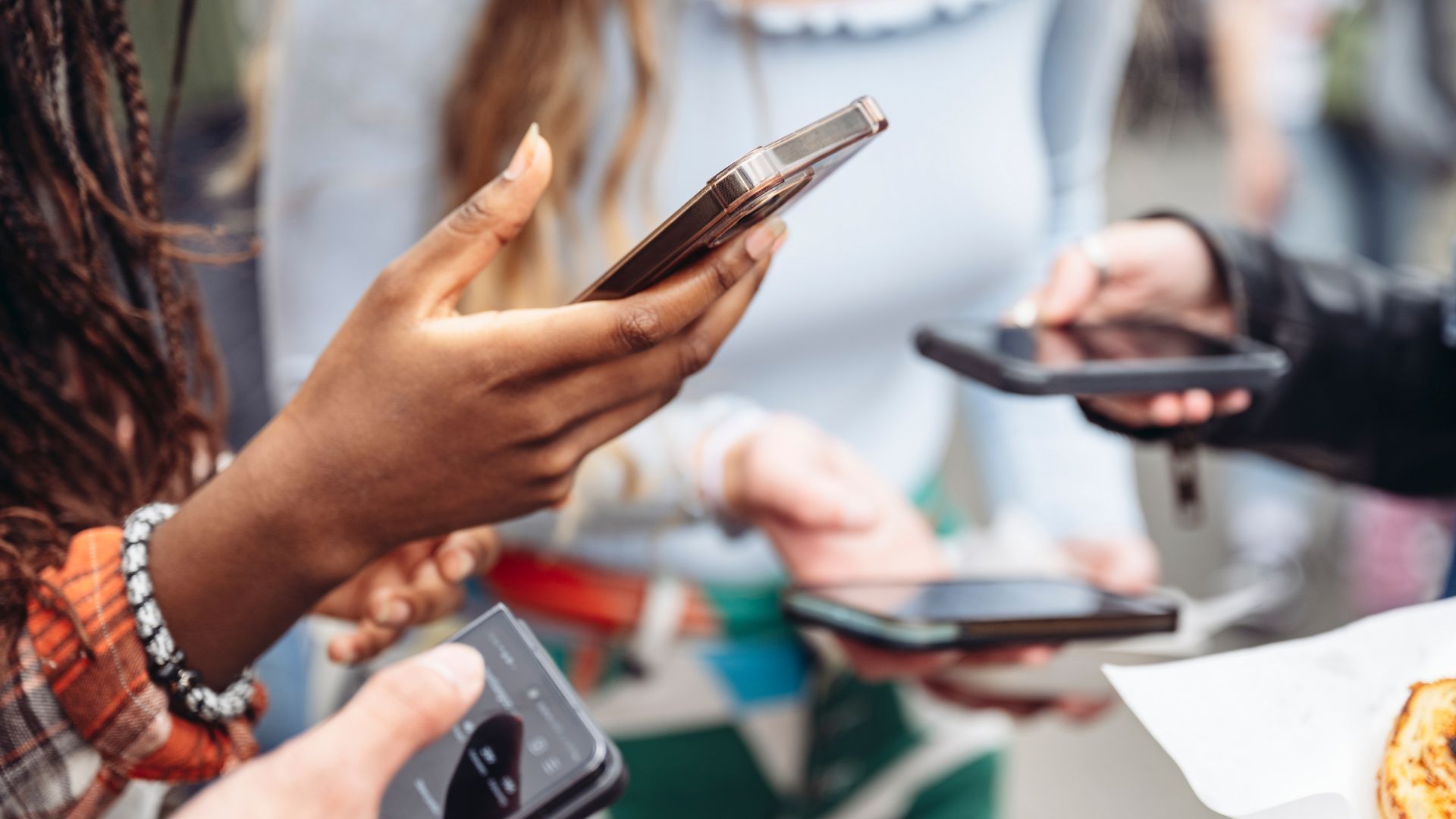 people holding phone to scroll